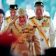 Sultan Muhammad V, center, salutes after his welcome ceremony as he walks with Malaysian Prime Minister Najib Razak, right, at the Parliament House in Kuala Lumpur, Malaysia, Tuesday, Dec. 13, 2016. Sultan Muhammad V of Kelantan will serve a five-year term as King of Malaysia from Tuesday. (AP Photo/Vincent Thian)